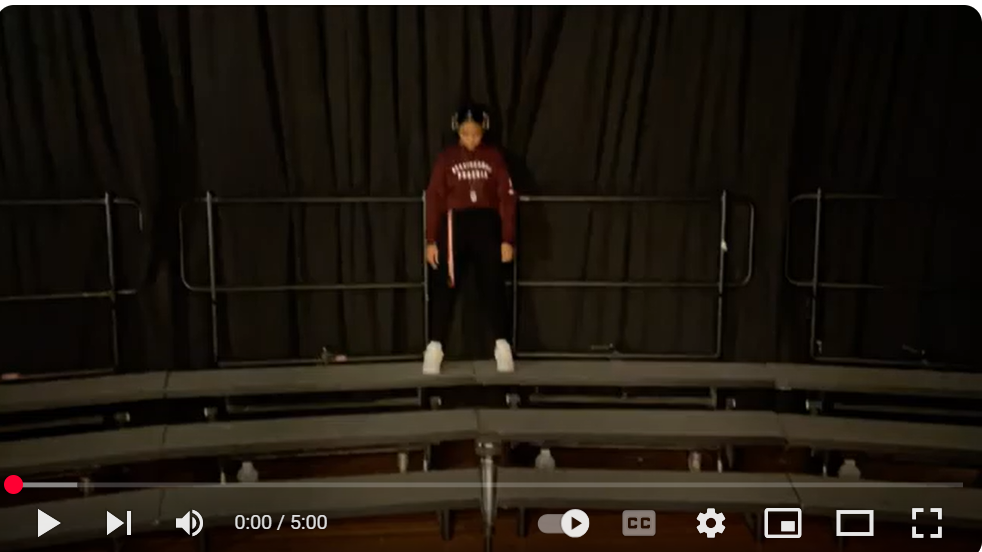  a female student standing on risers